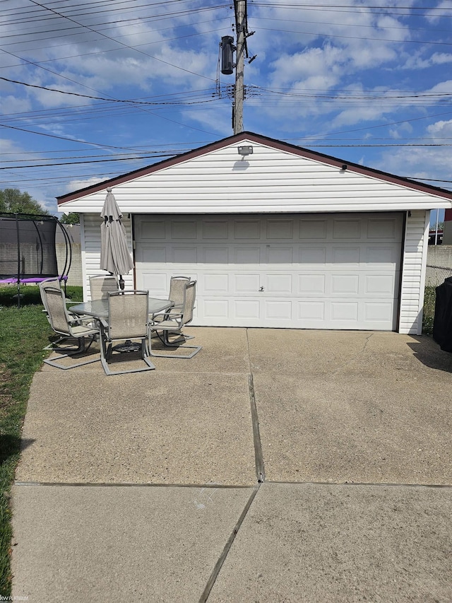 detached garage featuring a trampoline