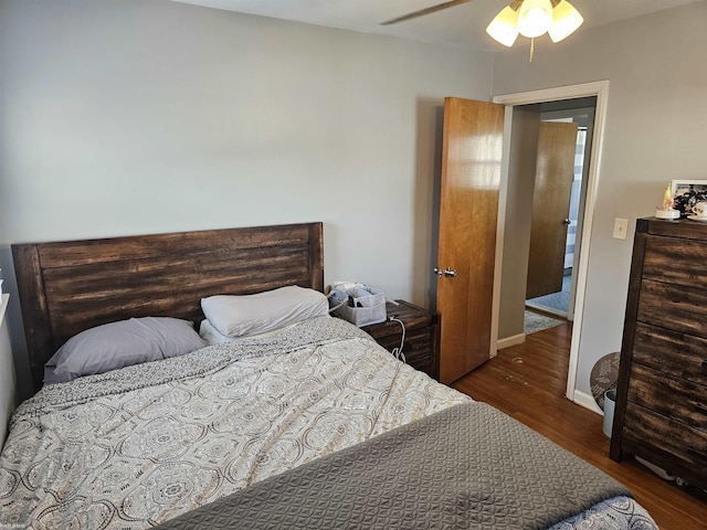 bedroom featuring baseboards, a ceiling fan, and wood finished floors