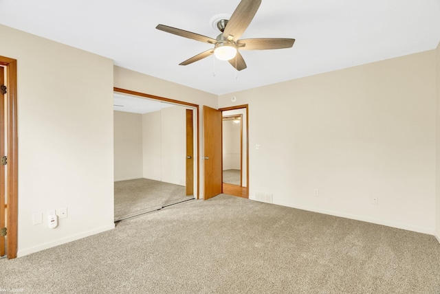 unfurnished bedroom featuring carpet flooring, baseboards, visible vents, and a closet