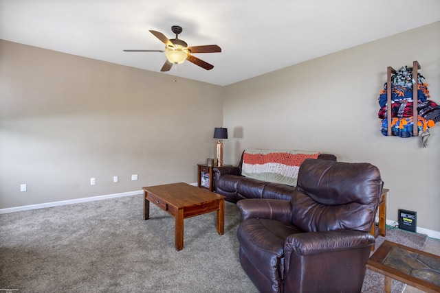 carpeted living room featuring baseboards and ceiling fan