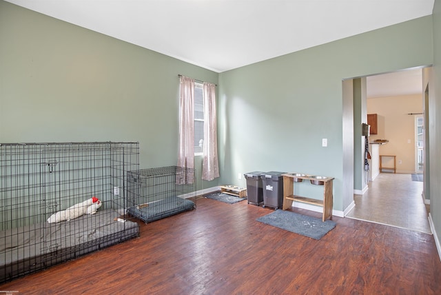 interior space featuring baseboards and wood finished floors