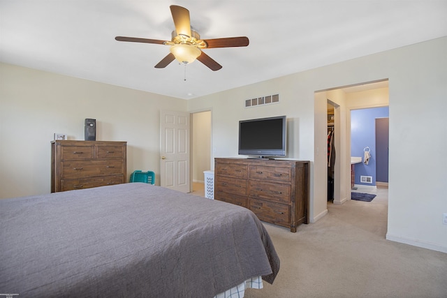 bedroom with a spacious closet, baseboards, and visible vents