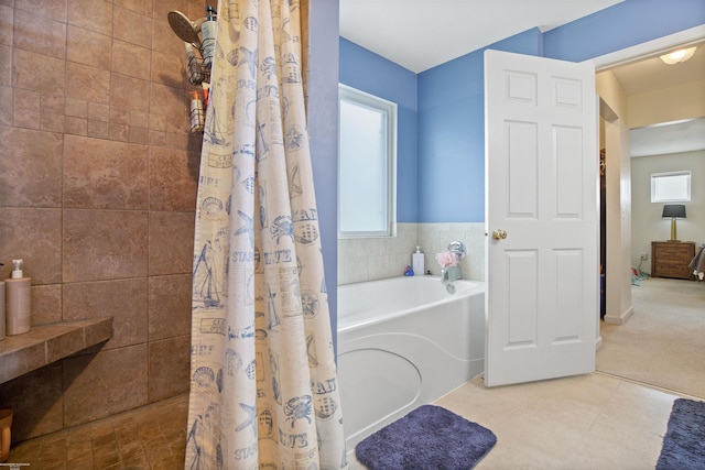 bathroom featuring a garden tub and a tile shower