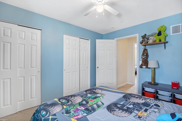 bedroom with visible vents, ceiling fan, and light colored carpet