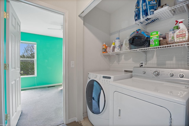 laundry area featuring baseboards, light carpet, independent washer and dryer, and laundry area