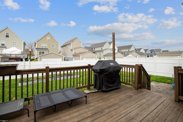 wooden terrace with a lawn, a fenced backyard, grilling area, and a residential view