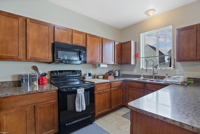 kitchen featuring a sink, brown cabinetry, and black appliances