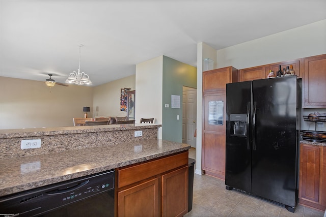 kitchen with brown cabinetry, pendant lighting, black appliances, and light stone countertops