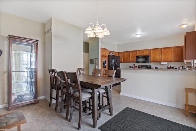 dining room with baseboards, a notable chandelier, light tile patterned floors, and visible vents