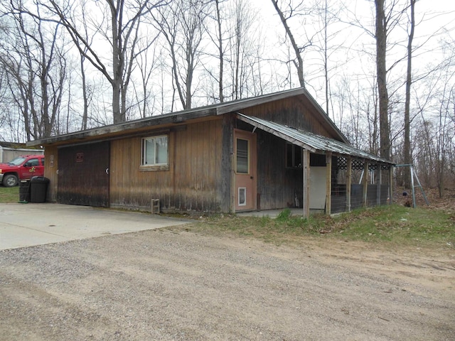 view of property exterior featuring dirt driveway