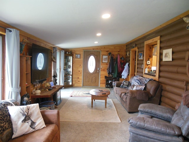living area featuring log walls and recessed lighting