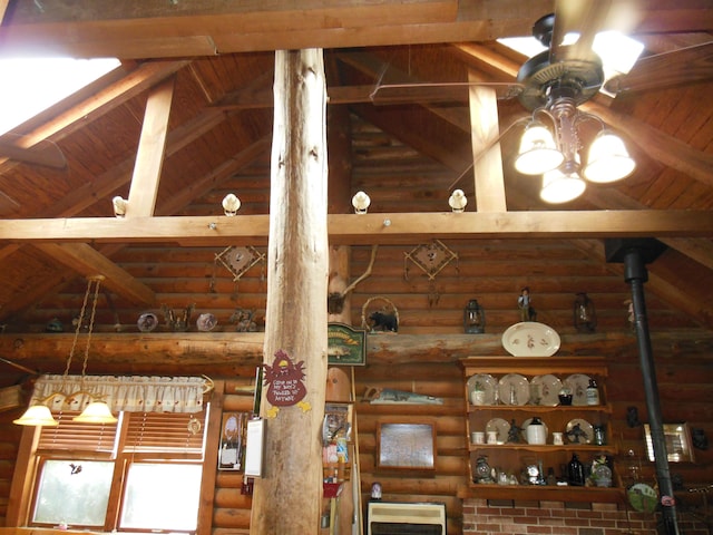interior details with heating unit, log walls, beam ceiling, ceiling fan, and wood ceiling