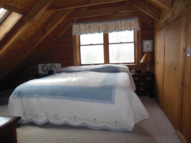 bedroom featuring lofted ceiling with beams and a closet
