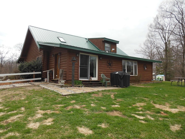 back of house with metal roof, fence, a yard, a patio, and entry steps