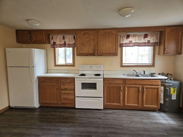 kitchen with brown cabinets, a sink, white appliances, light countertops, and electric water heater
