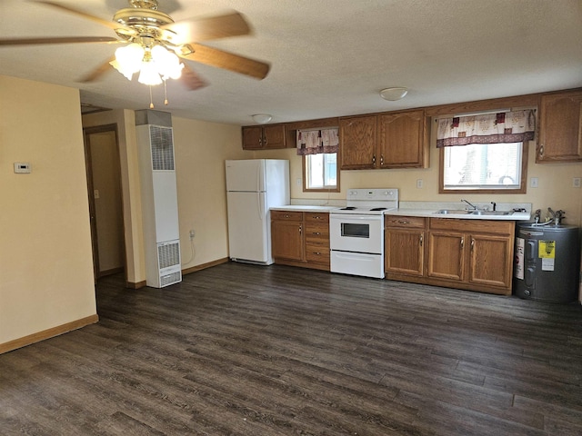 kitchen featuring brown cabinetry, a heating unit, water heater, and white appliances