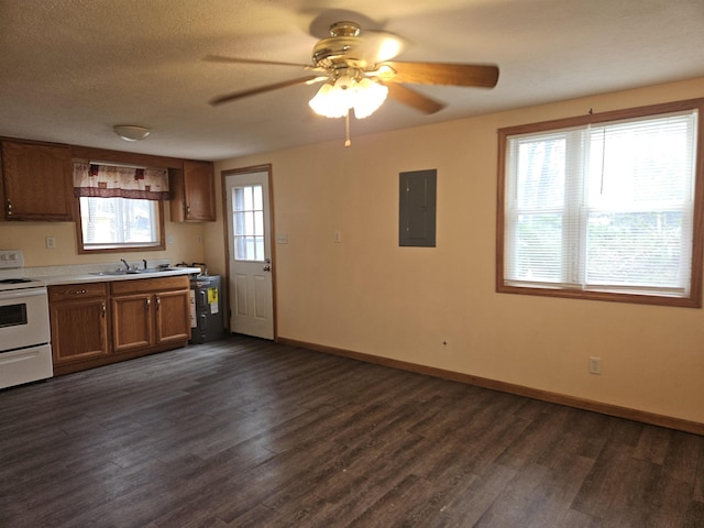kitchen featuring dark wood-style flooring, ceiling fan, light countertops, electric panel, and electric stove