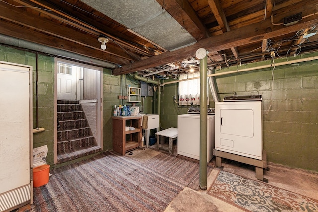 basement featuring a sink, stairs, and washing machine and dryer
