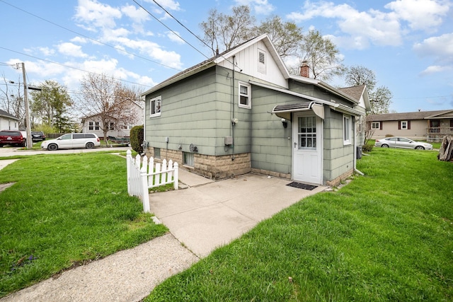 exterior space featuring a lawn and a chimney