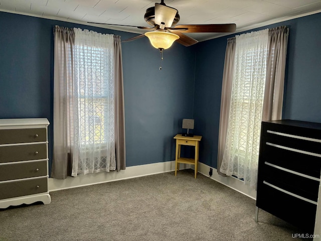 bedroom with a ceiling fan and carpet