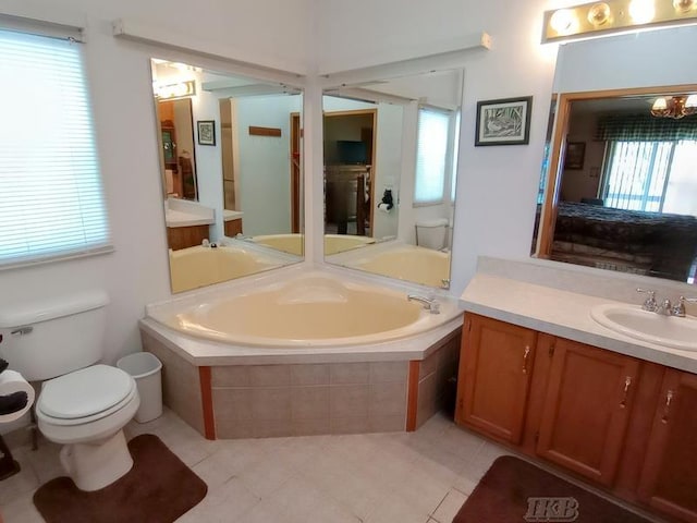 bathroom featuring toilet, tile patterned flooring, a garden tub, and vanity