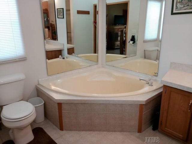 full bathroom with vanity, a garden tub, and toilet
