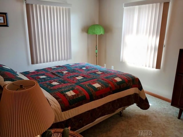 carpeted bedroom featuring baseboards