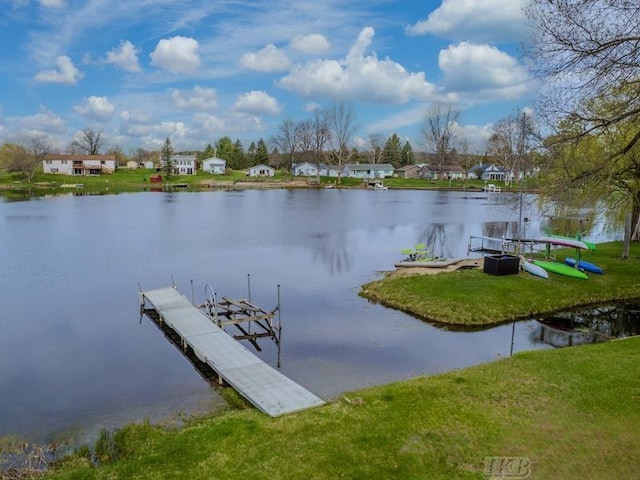 view of dock with a lawn, a water view, and a residential view