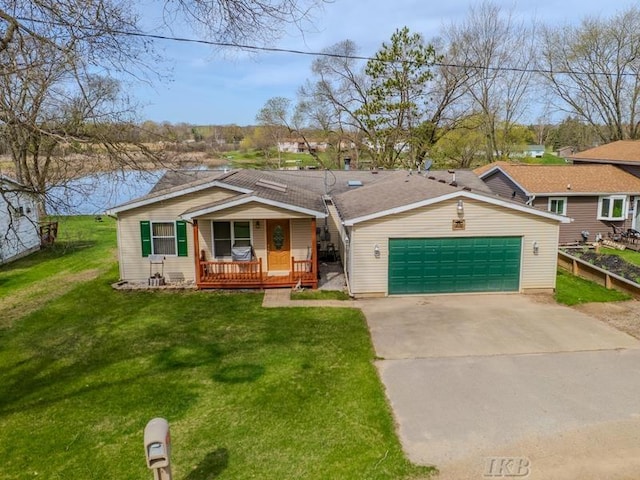 view of front of house with a garage, a front lawn, a porch, and driveway