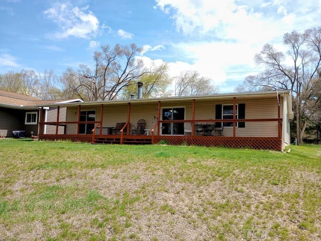 back of property featuring a lawn