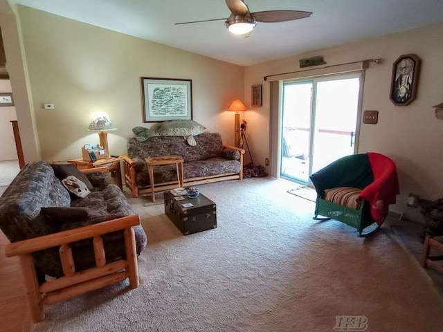 living room with ceiling fan, carpet, and vaulted ceiling