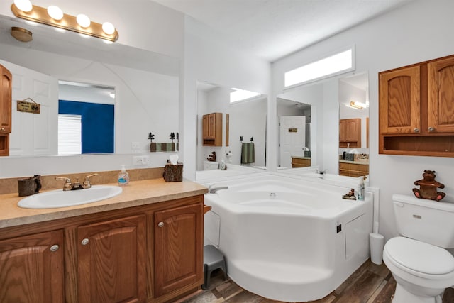 3160 Highland Pkwy, Gladwin, MI 48624 - full bath featuring a healthy amount of sunlight, a garden tub, toilet, and wood finished floors