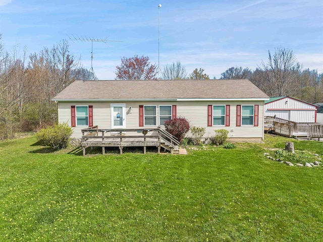 3160 Highland Pkwy, Gladwin, MI 48624 - rear view of house with a shingled roof, a yard, and a deck