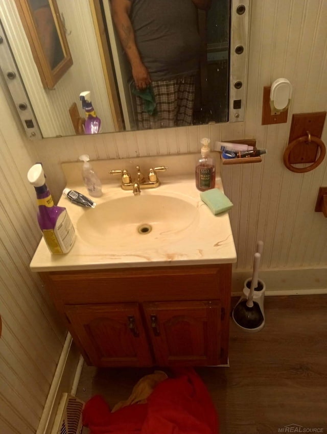 bathroom with vanity and wood finished floors