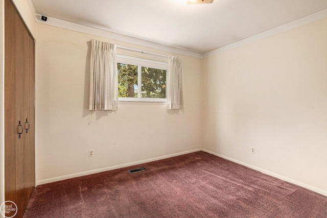 unfurnished room featuring carpet floors, baseboards, and visible vents