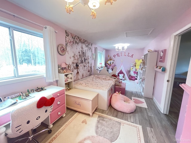 131 Midway Dr, Negaunee, MI 49866 - bedroom featuring multiple windows, light wood-style floors, a chandelier, and attic access