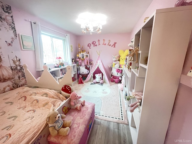 131 Midway Dr, Negaunee, MI 49866 - bedroom with wood finished floors and a chandelier