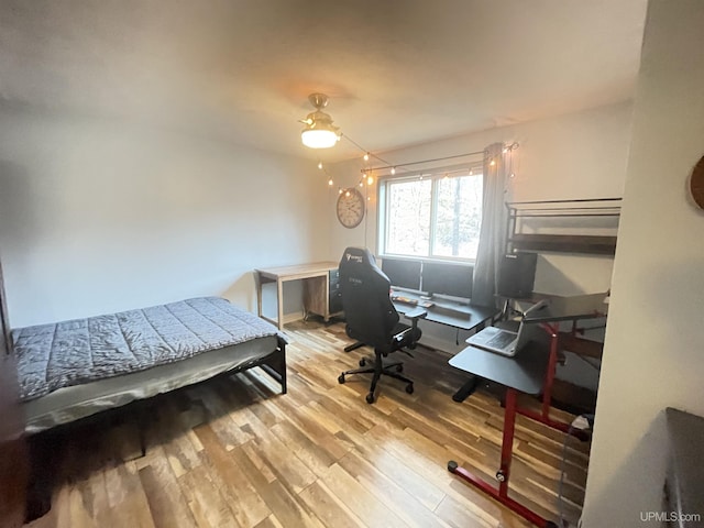 131 Midway Dr, Negaunee, MI 49866 - bedroom with wood finished floors, a desk, and a ceiling fan