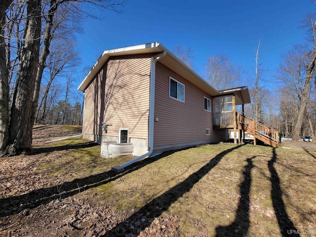 131 Midway Dr, Negaunee, MI 49866 - view of home's exterior featuring stairway and a lawn