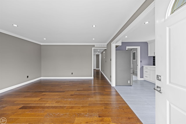 unfurnished room with recessed lighting, baseboards, visible vents, and wood finished floors