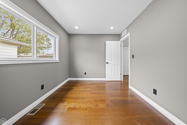 spare room with recessed lighting, baseboards, visible vents, and wood finished floors