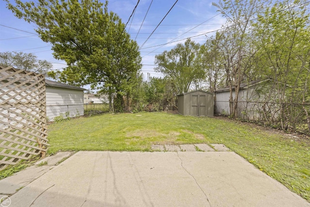 view of yard with a patio, an outbuilding, a shed, and a fenced backyard