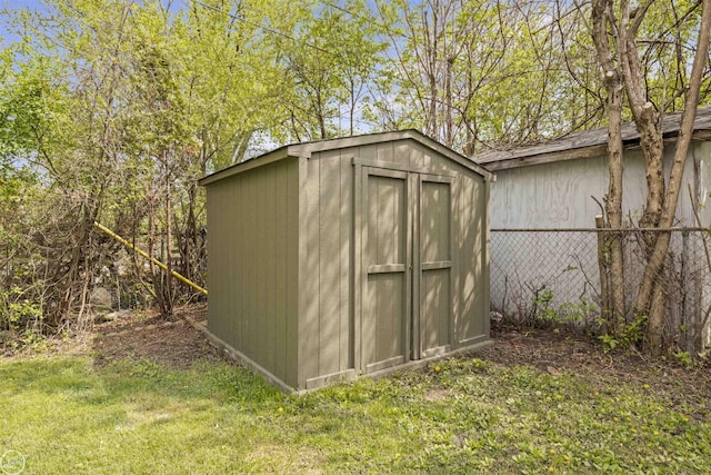 view of shed featuring fence