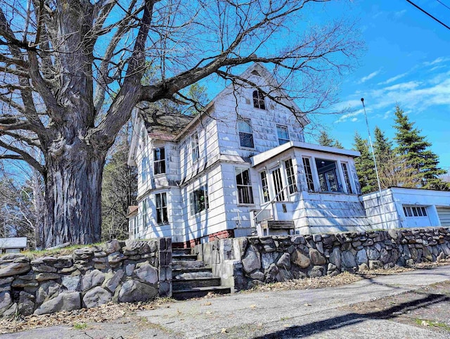 view of front of property featuring a sunroom