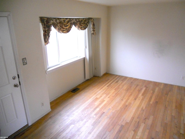 empty room with visible vents and light wood-style flooring