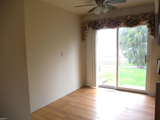 spare room featuring a ceiling fan and light wood-style flooring