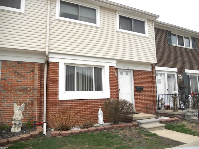 view of property featuring brick siding