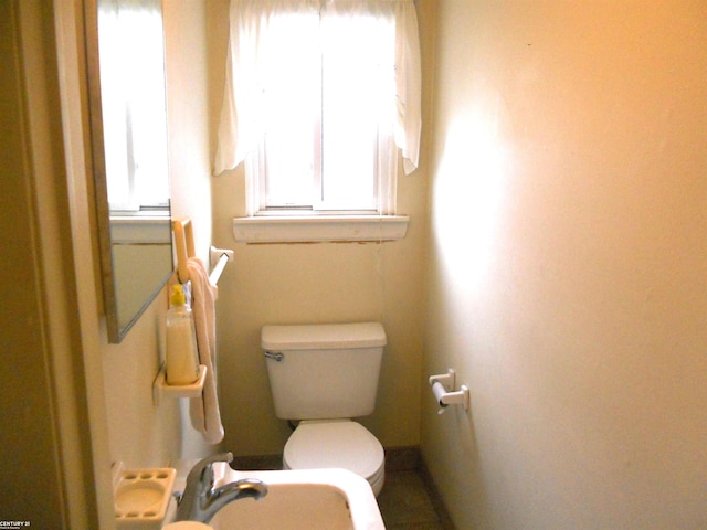 half bathroom with a sink and toilet
