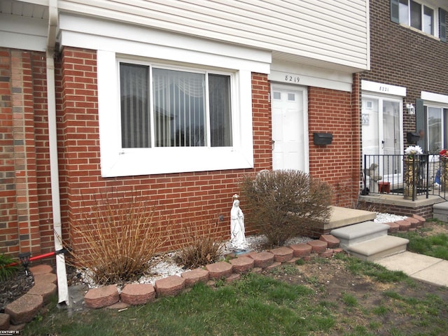 entrance to property with brick siding