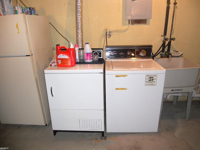clothes washing area featuring washer and dryer, laundry area, a sink, and electric panel
